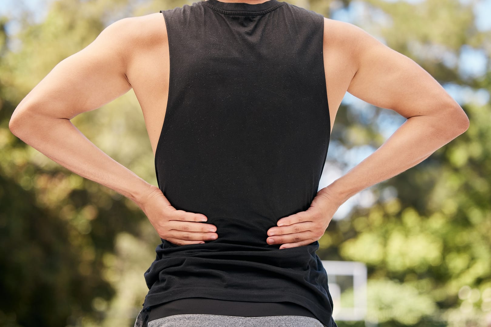 Athlete with back pain, injury or accident from sports match or training on an outdoor court. The Back Pain Project helps with Sports pain in hand Stamford Darien Norwalk and New Canaan 203-656-3638
